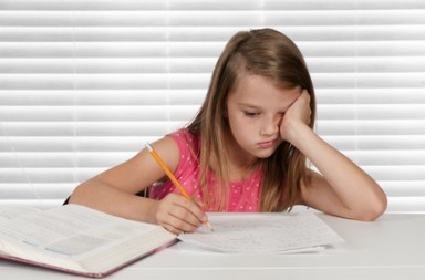 Pretty little girl doing her school homework