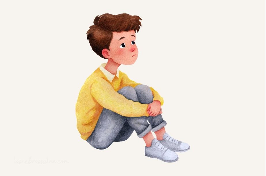 Niño sentado que se siente diferente y solo, representando emociones infantiles como rechazo, tristeza o inseguridad